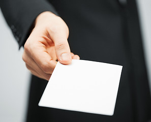 Image showing man in suit holding credit card