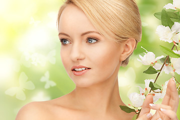 Image showing beautiful woman with flowers on twig