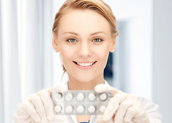 Image showing attractive female doctor with pills