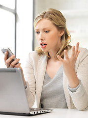 Image showing confused woman with cell phone