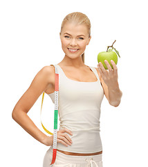 Image showing sporty woman with apple and measuring tape