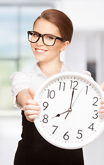 Image showing woman holding big clock