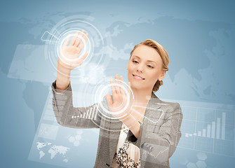 Image showing businesswoman touching virtual screen