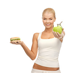 Image showing woman with apple and hamburger