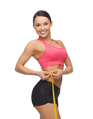 Image showing sporty woman with measuring tape