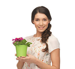 Image showing lovely housewife with flower in pot