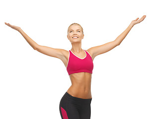 Image showing sportswoman with raised up hands