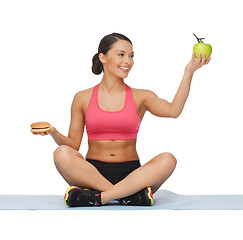 Image showing woman with apple and hamburger