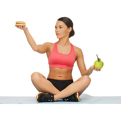 Image showing woman with apple and hamburger