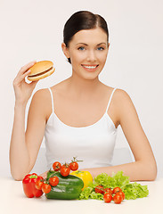 Image showing woman with hamburger and vegetables