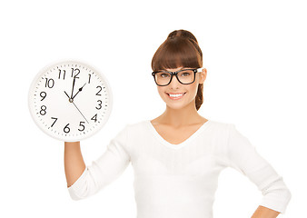 Image showing businesswoman with wall clock