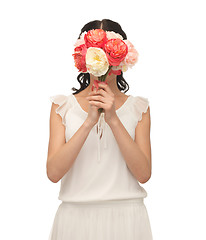 Image showing woman holding bouquet of flowers over her face