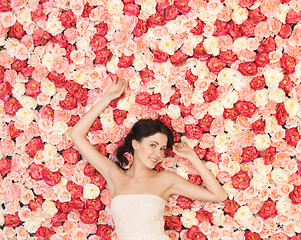 Image showing young woman with background full of roses