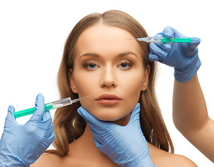 Image showing woman face and beautician hands