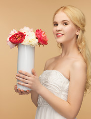 Image showing woman with vase of flowers