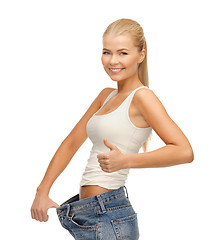 Image showing sporty woman showing big pants