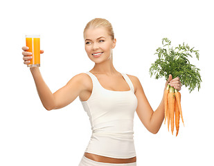 Image showing woman holding glass of juice and carrots