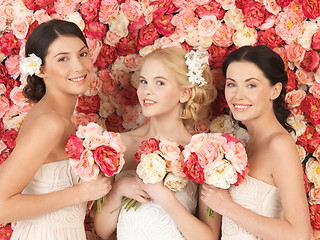 Image showing three women with background full of roses