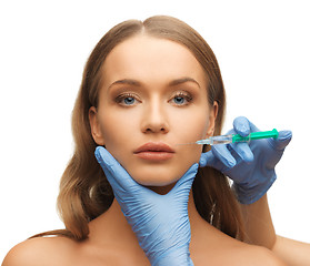 Image showing woman face and beautician hands