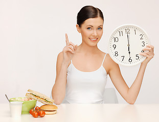 Image showing woman with big clock