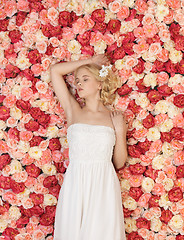 Image showing young woman with background full of roses