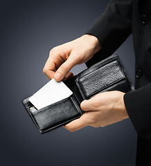 Image showing man in suit holding credit card