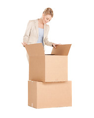 Image showing businesswoman unpacking big boxes