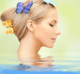 Image showing woman with butterflies in hair