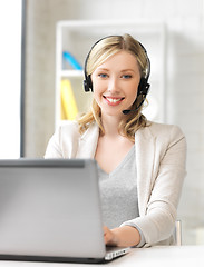 Image showing friendly female helpline operator with laptop