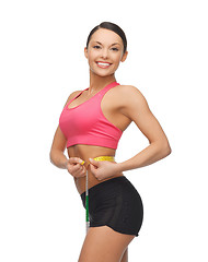 Image showing sporty woman with measuring tape