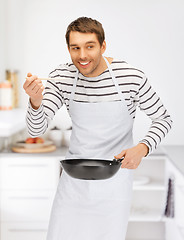 Image showing handsome man with pan at kitchen