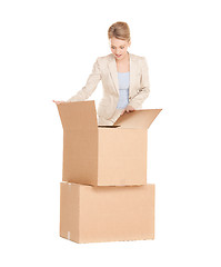 Image showing businesswoman unpacking big boxes