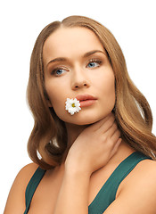 Image showing woman with camomile in mouth