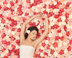 Image showing young woman with background full of roses