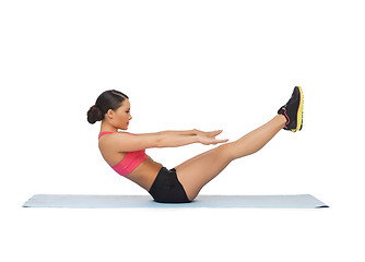 Image showing sporty woman doing exercise on the floor