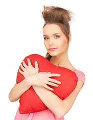 Image showing happy and smiling woman with heart-shaped pillow