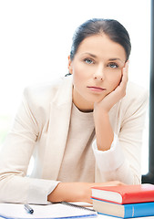 Image showing bored and tired woman behid the table