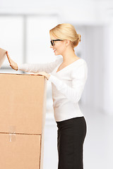 Image showing attractive businesswoman with big boxes