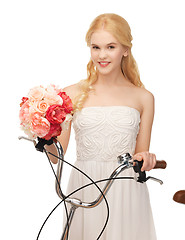 Image showing country girl with bicycle and flowers