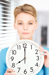 Image showing woman holding big clock