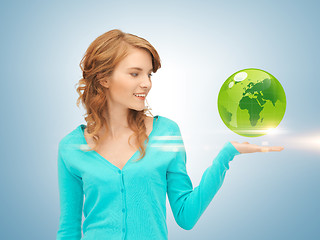 Image showing woman holding green globe on her hand