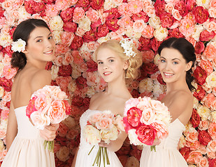 Image showing three women with background full of roses