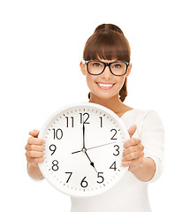 Image showing businesswoman with wall clock