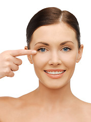 Image showing beautiful woman pointing to eye