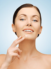 Image showing beautiful woman pointing to chin