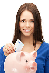 Image showing lovely woman with piggy bank and money