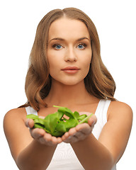 Image showing woman with spinach leaves on palms