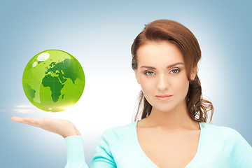 Image showing woman holding green globe on her hand