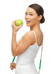 Image showing woman with measuring tape and apple