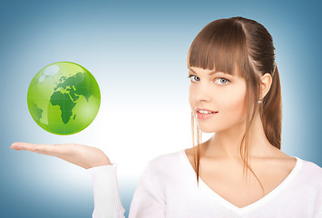 Image showing woman holding green globe on her hand